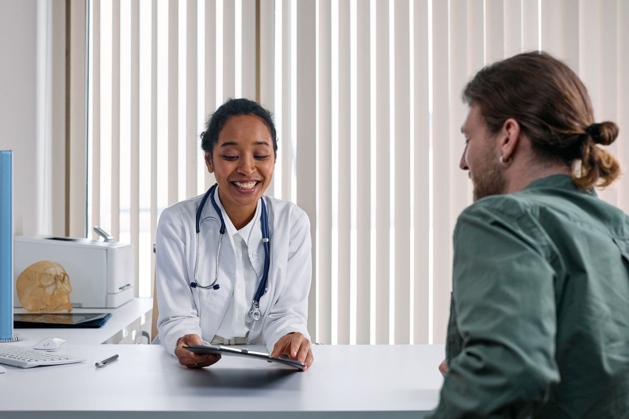 Healthcare professional consulting with a patient in a clinical setting